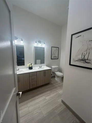 a bathroom with a double vanity sink and a mirror