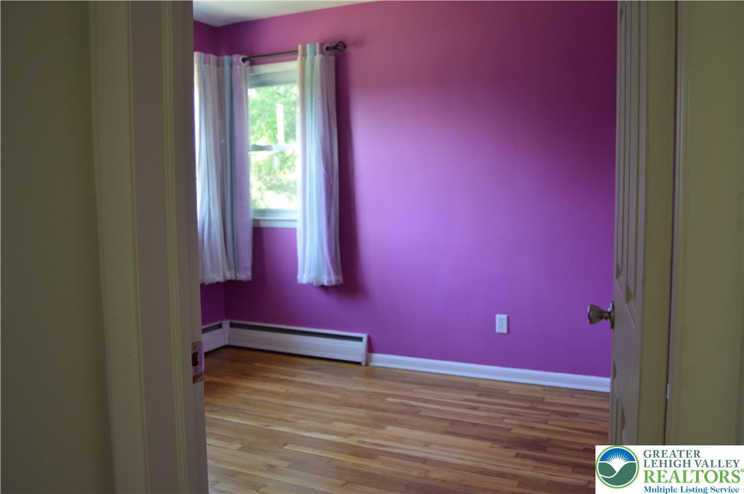 1819 Blue Barn Road Orefield, PA 18069 - Photo 15 of 21 Hardwood floors and a well-lit window define this cozy bedroom space.