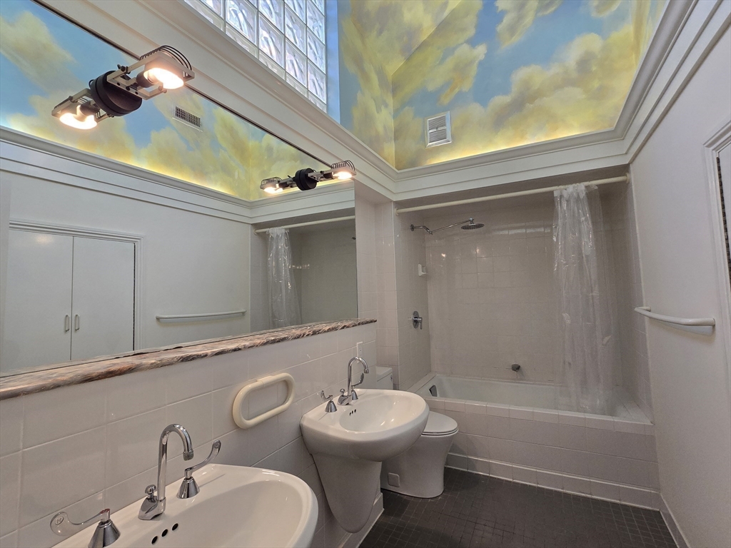 61 Otis Street, Unit 3 Cambridge, MA 02141 - Photo 11 of 18 a bathroom with a sink a toilet and shower