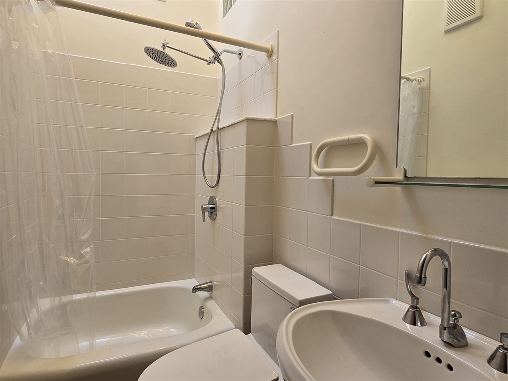 61 Otis Street, Unit 3 Cambridge, MA 02141 - Photo 13 of 18 a bathroom with a sink a toilet and shower
