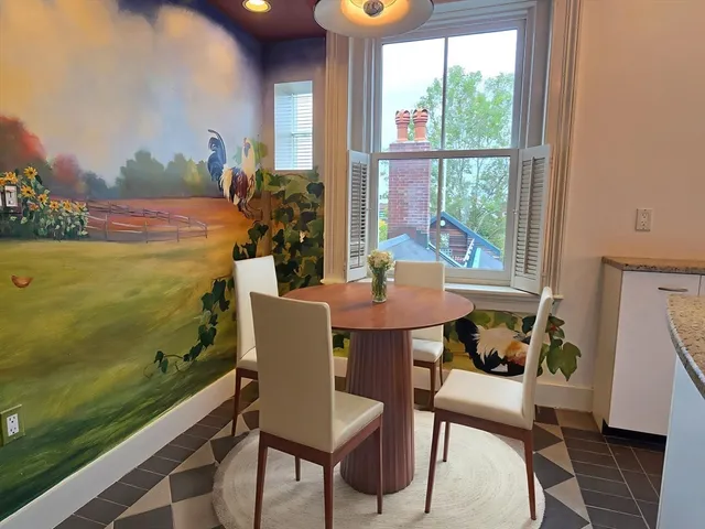a view of a dining room with furniture and window