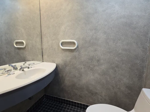 a bathroom with a sink mirror vanity and toilet