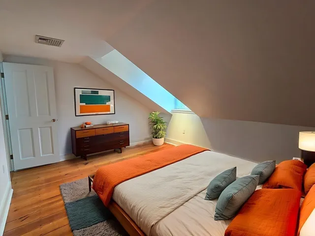 a bedroom with bed and window