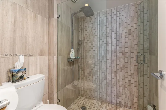 a bathroom with a toilet and shower