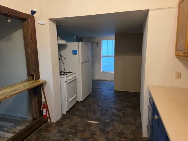 a kitchen with a refrigerator and a stove