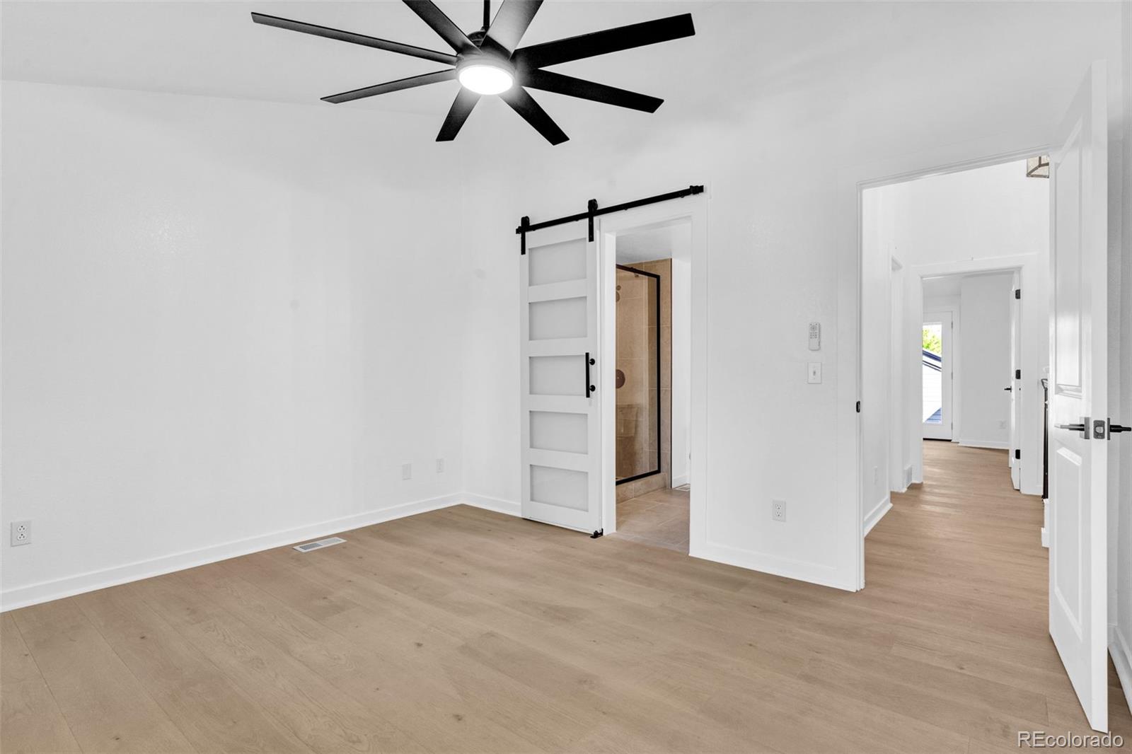 5051 Garrison Street, Unit 7C Wheat Ridge, CO 80033 - Photo 12 of 27 a view of a big room with wooden floor and windows in a room