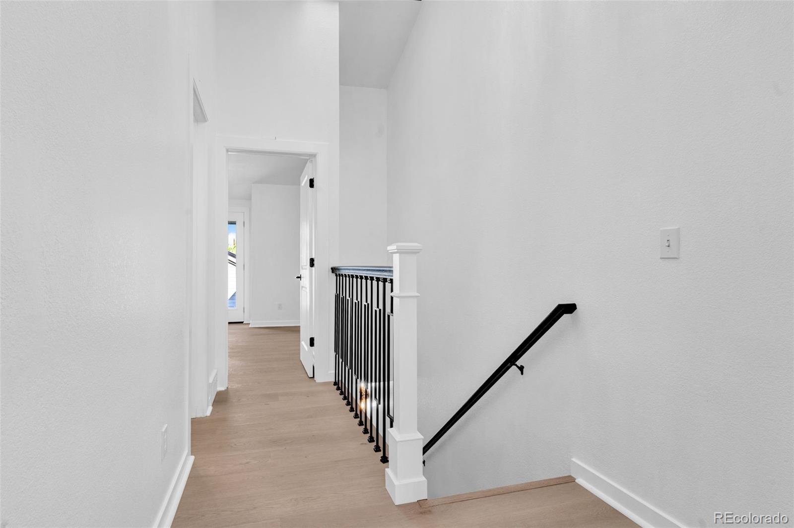 5051 Garrison Street, Unit 7C Wheat Ridge, CO 80033 - Photo 15 of 27 a view of a hallway with staircase