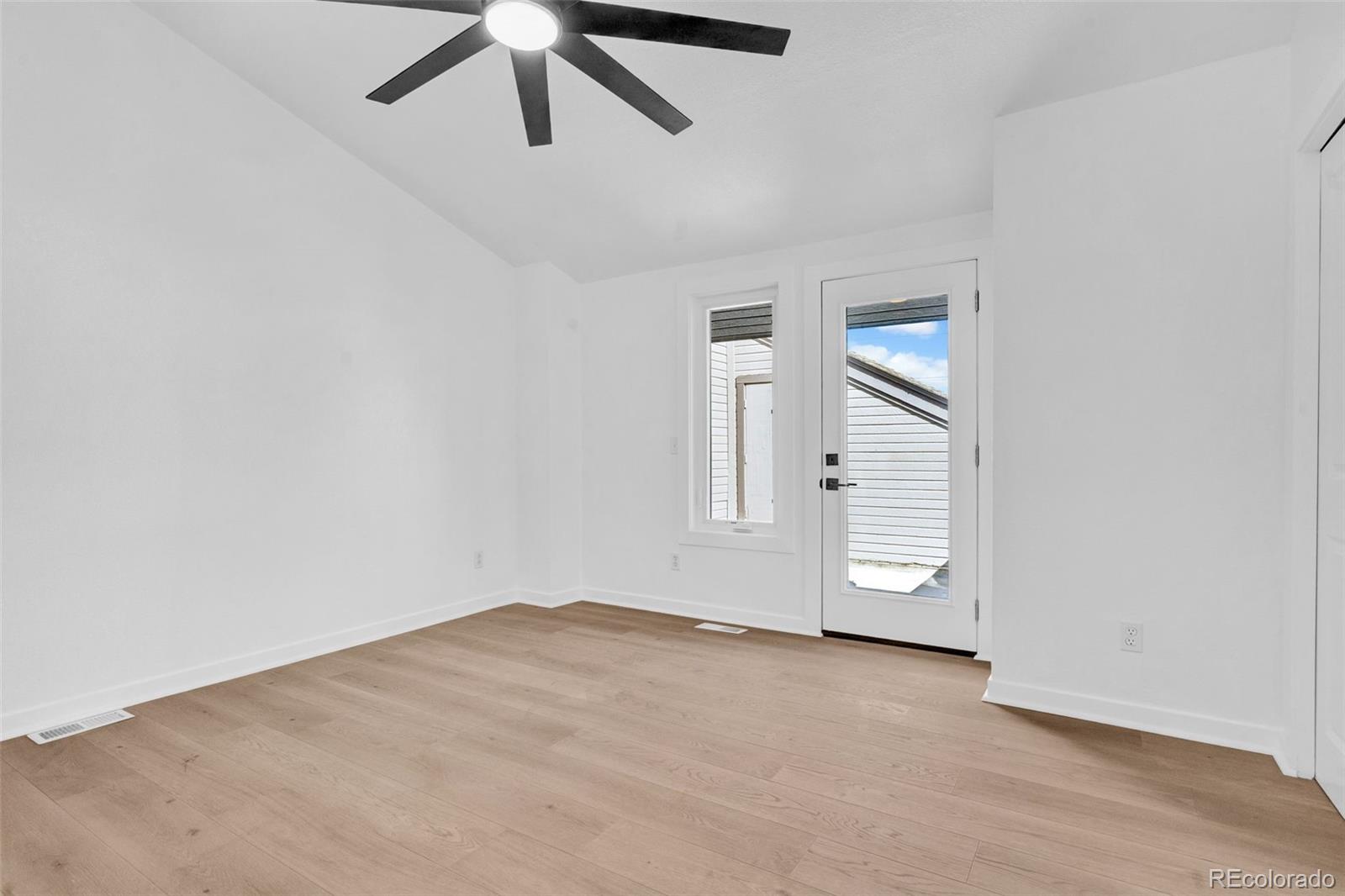 5051 Garrison Street, Unit 7C Wheat Ridge, CO 80033 - Photo 18 of 27 an empty room with closet and windows