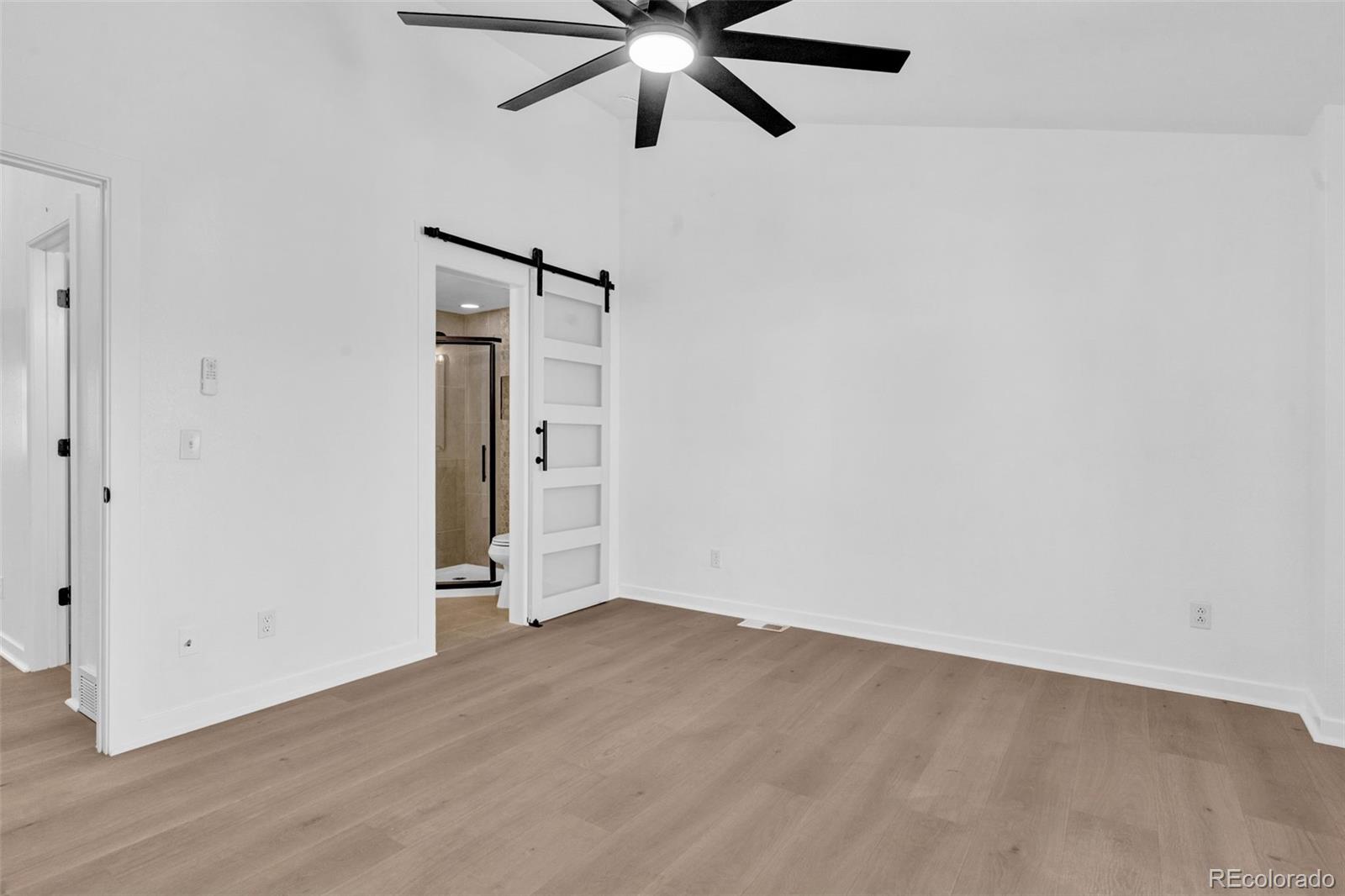 5051 Garrison Street, Unit 7C Wheat Ridge, CO 80033 - Photo 20 of 27 an empty room with closet and a ceiling fan