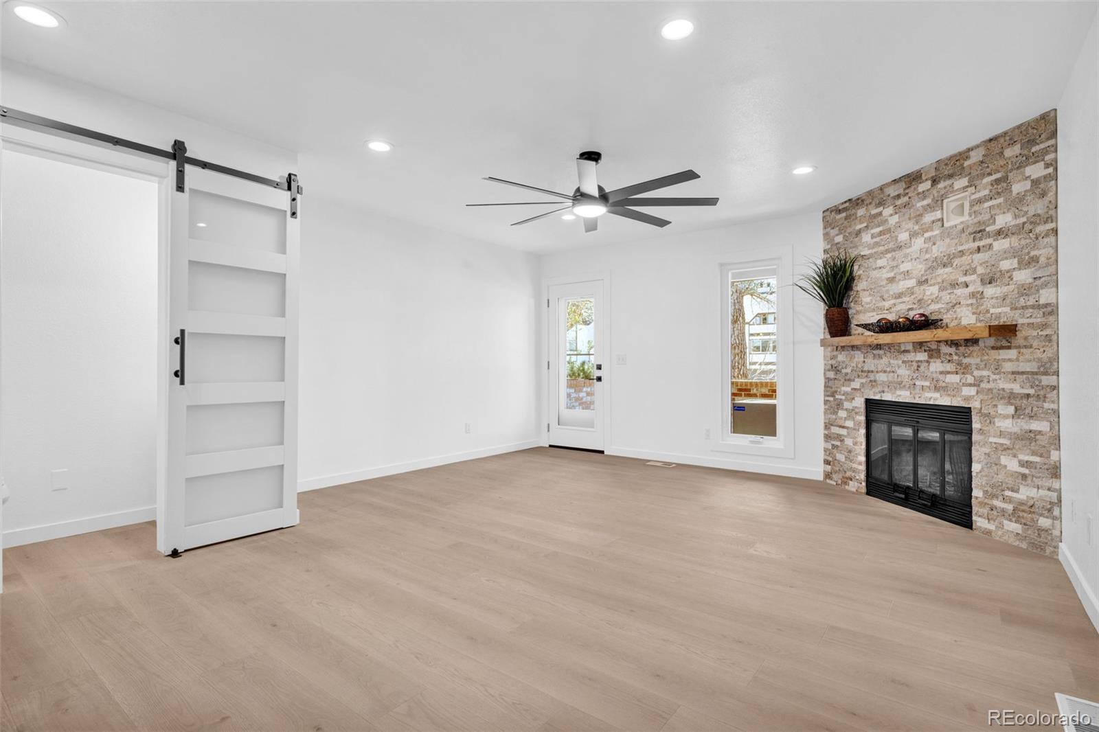 5051 Garrison Street, Unit 7C Wheat Ridge, CO 80033 - Photo 4 of 27 a view of an empty room with a fireplace