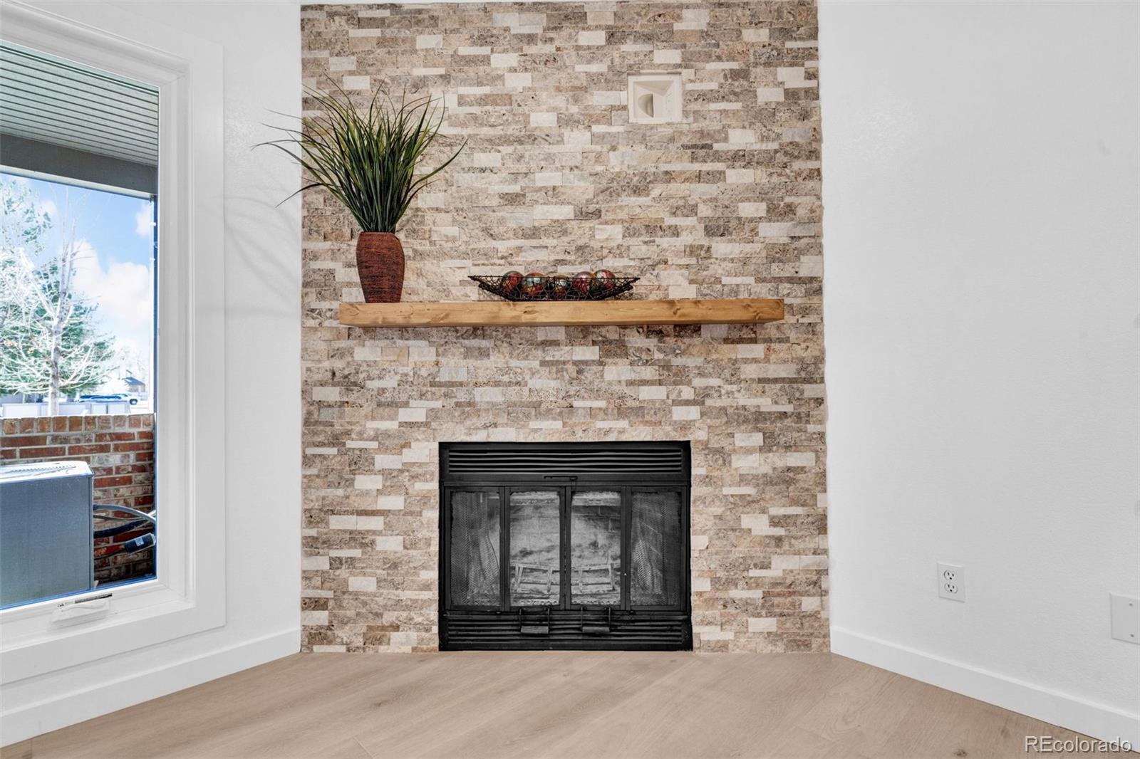 5051 Garrison Street, Unit 7C Wheat Ridge, CO 80033 - Photo 5 of 27 a stone house with a potted plant on it