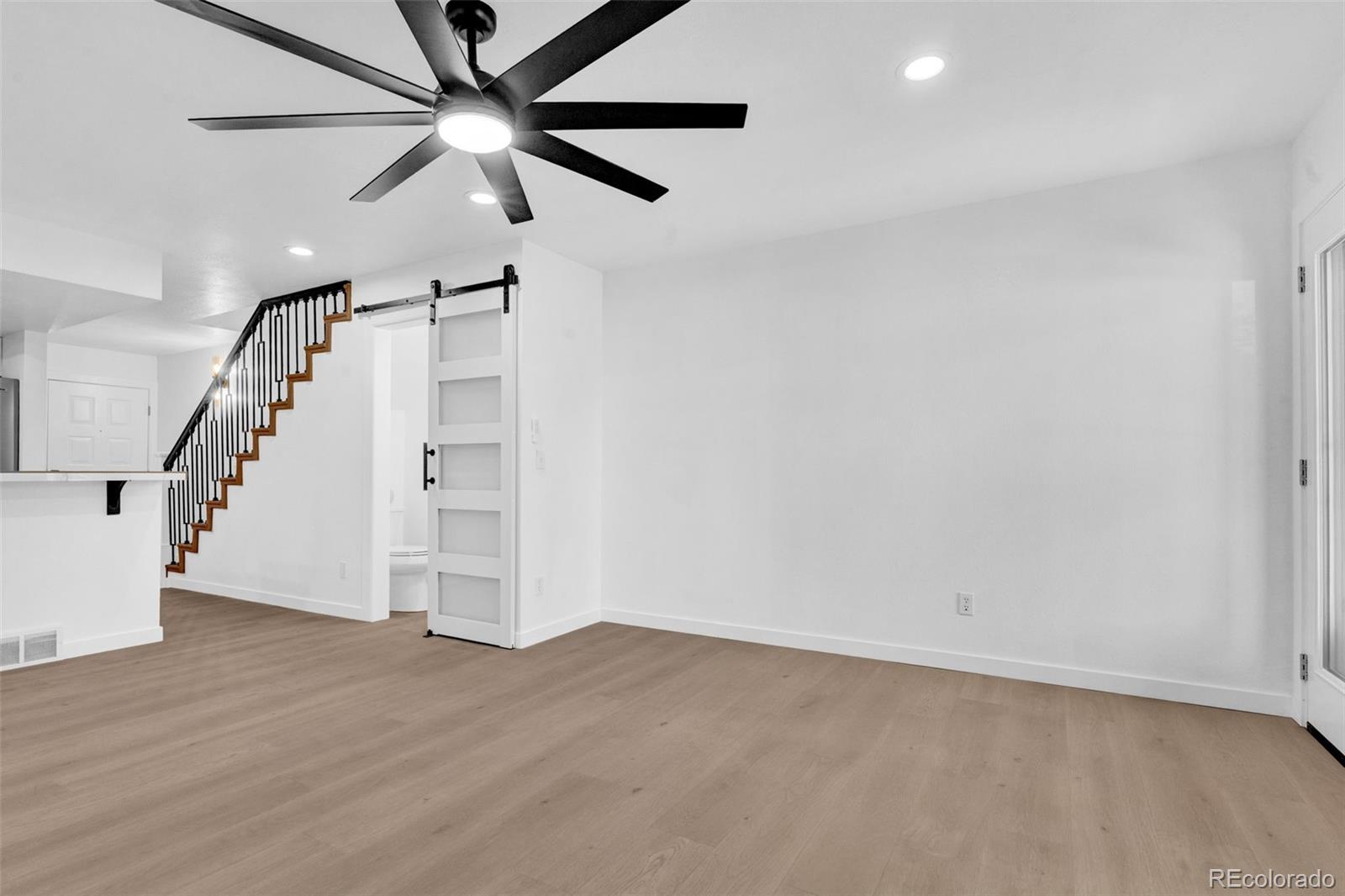 5051 Garrison Street, Unit 7C Wheat Ridge, CO 80033 - Photo 8 of 27 wooden floor in an empty room