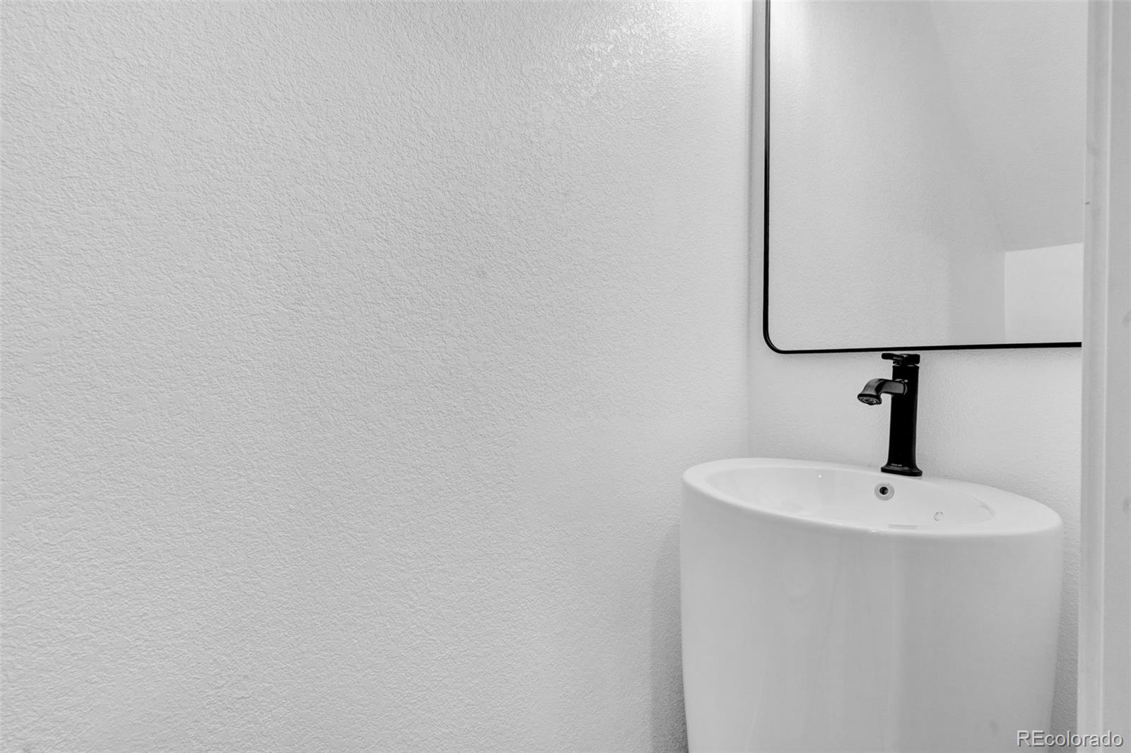 5051 Garrison Street, Unit 7C Wheat Ridge, CO 80033 - Photo 10 of 27 a bathroom with a sink and mirror