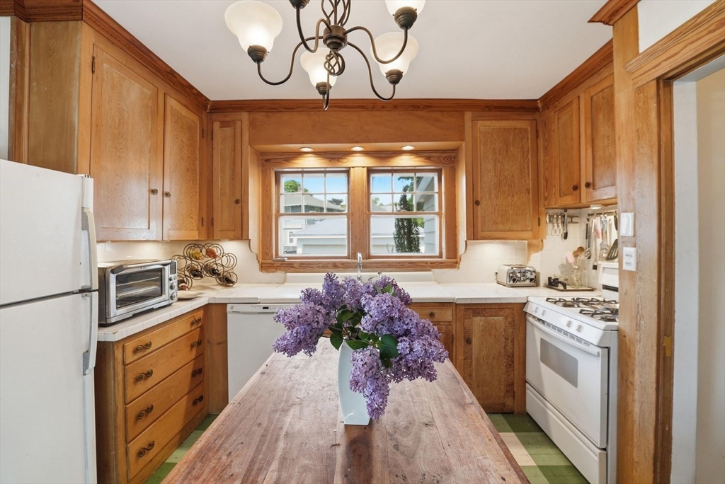 19 Humphrey Street Marblehead, MA 01945 - Photo 9 of 29 a kitchen with stainless steel appliances a stove a sink dishwasher and a refrigerator