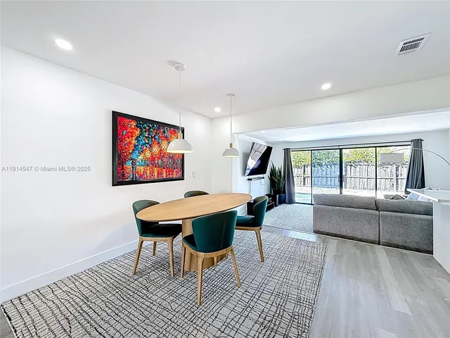 a living room with furniture a rug and a large window