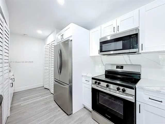 a kitchen with appliances and cabinets