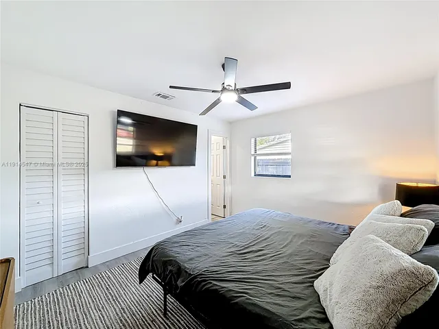 a bedroom with a large bed and a window