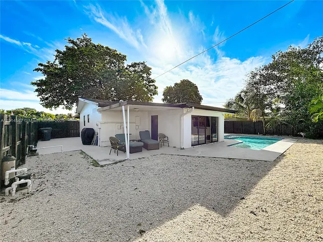 a backyard of a house with barbeque oven