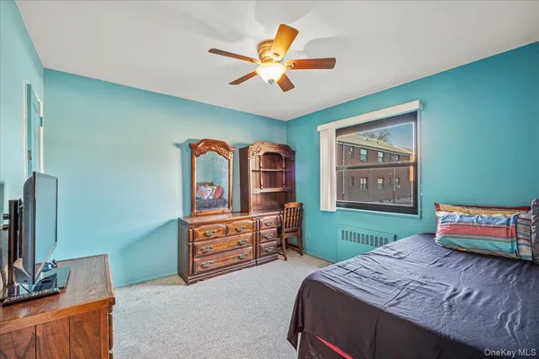 a bed room with a bed and a television