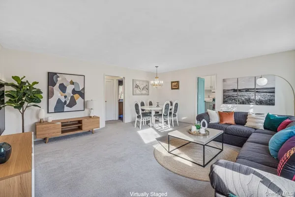 a living room with furniture and a painting