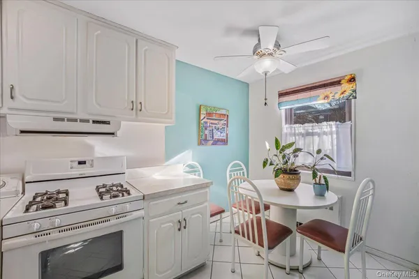 a kitchen with a stove a table and chairs