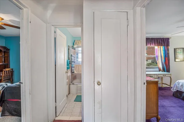 a bedroom with a bed dresser and a window
