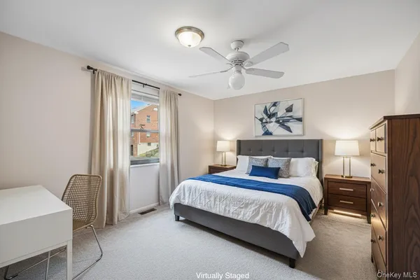 a bedroom with a bed a dresser next to a window