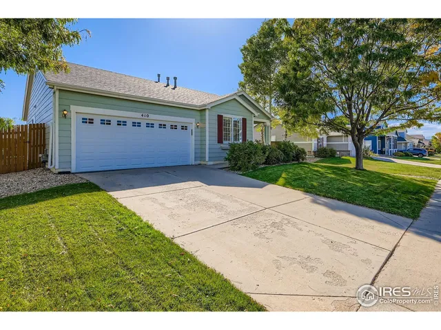a view of a house with a yard and a garage