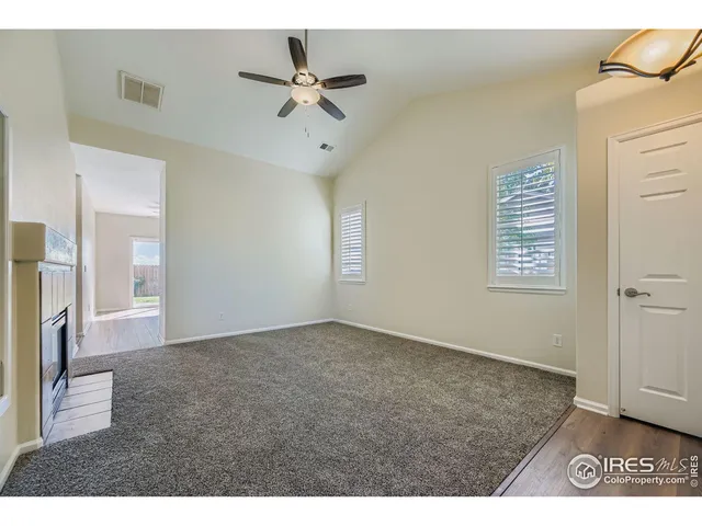 a view of an empty room and a window