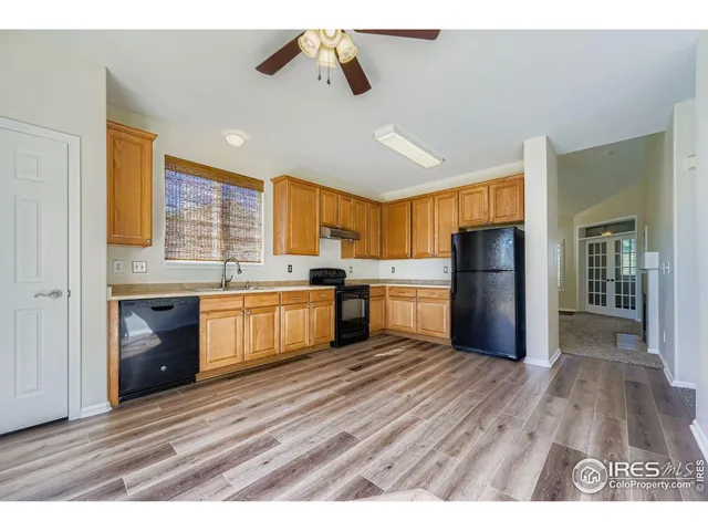 a kitchen with a refrigerator and a stove top oven