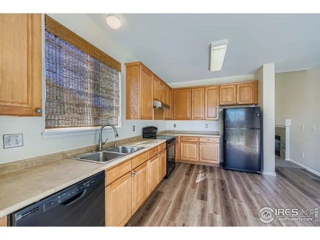 a kitchen with a sink stove and refrigerator