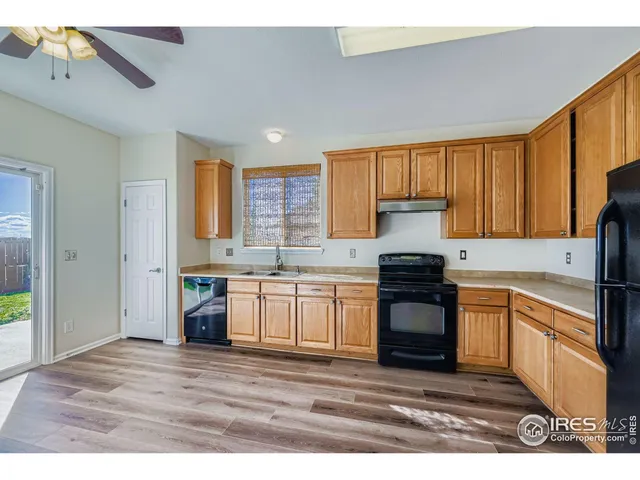 a kitchen with stainless steel appliances granite countertop a stove sink and cabinets