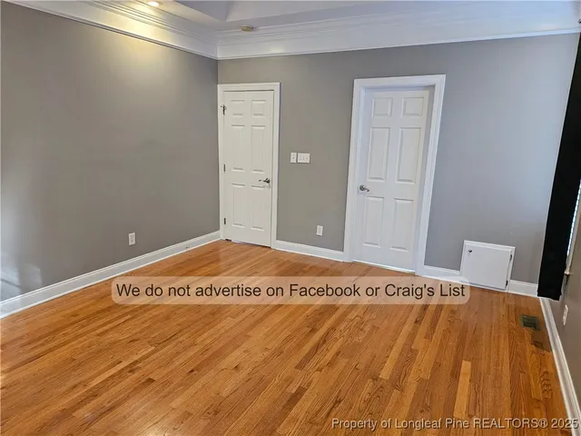 a view of a room with wooden floor