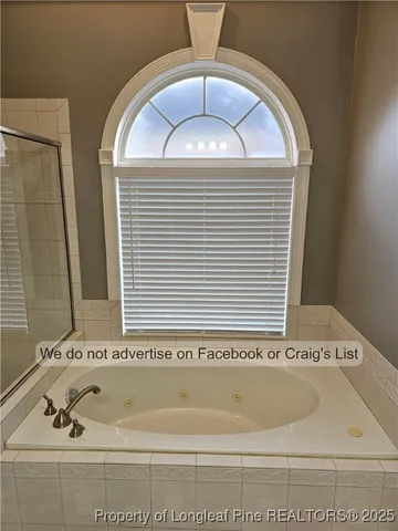 a bathroom with a bathtub and a window