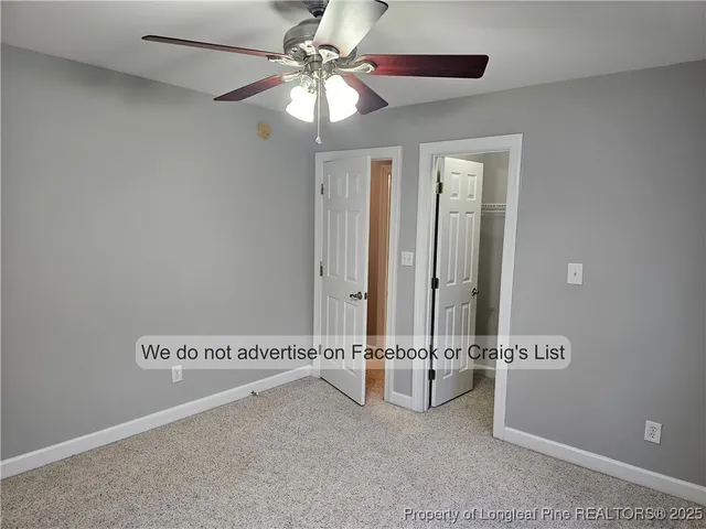 an entryway with a table and a chandelier fan