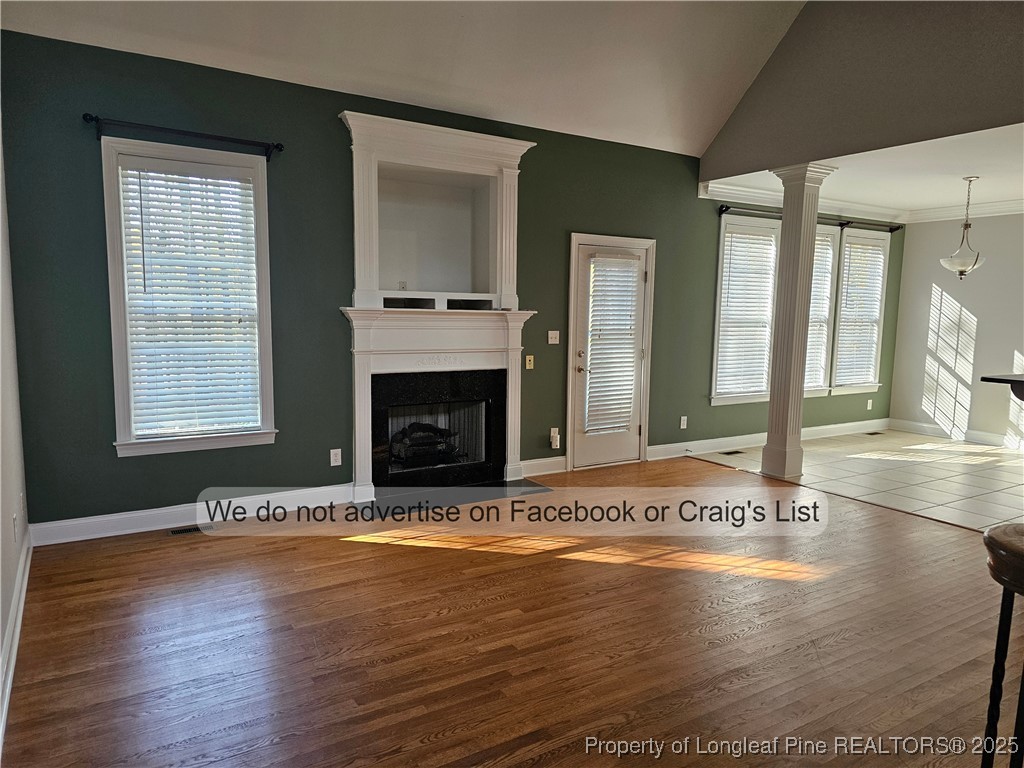 50 Barons Run East Spring Lake, NC 28390 - Photo 6 of 28 an empty room with wooden floor and a fireplace