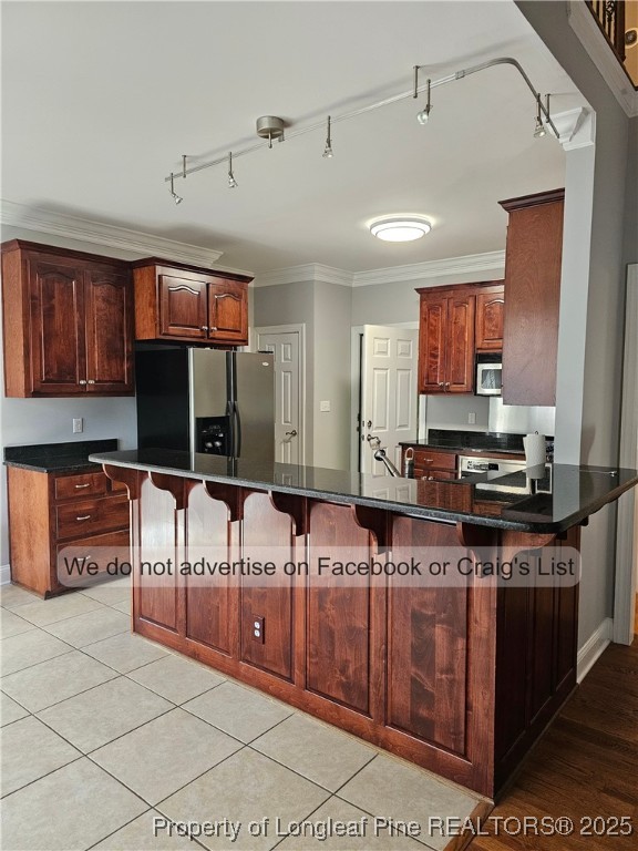 50 Barons Run East Spring Lake, NC 28390 - Photo 8 of 28 a kitchen with stainless steel appliances granite countertop a stove a sink and a microwave