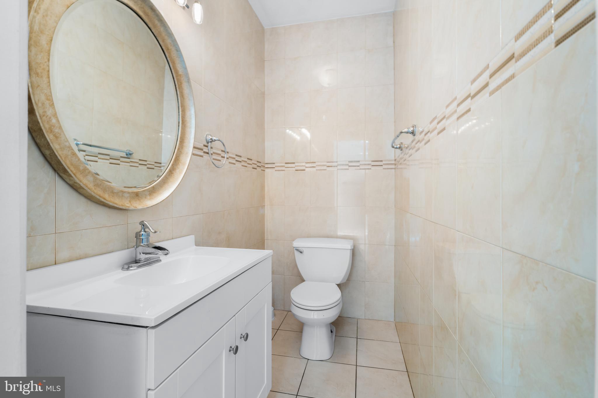 7510 Gilley Terrace Rosedale, MD 21237 - Photo 12 of 46 a bathroom with a sink a toilet and a mirror