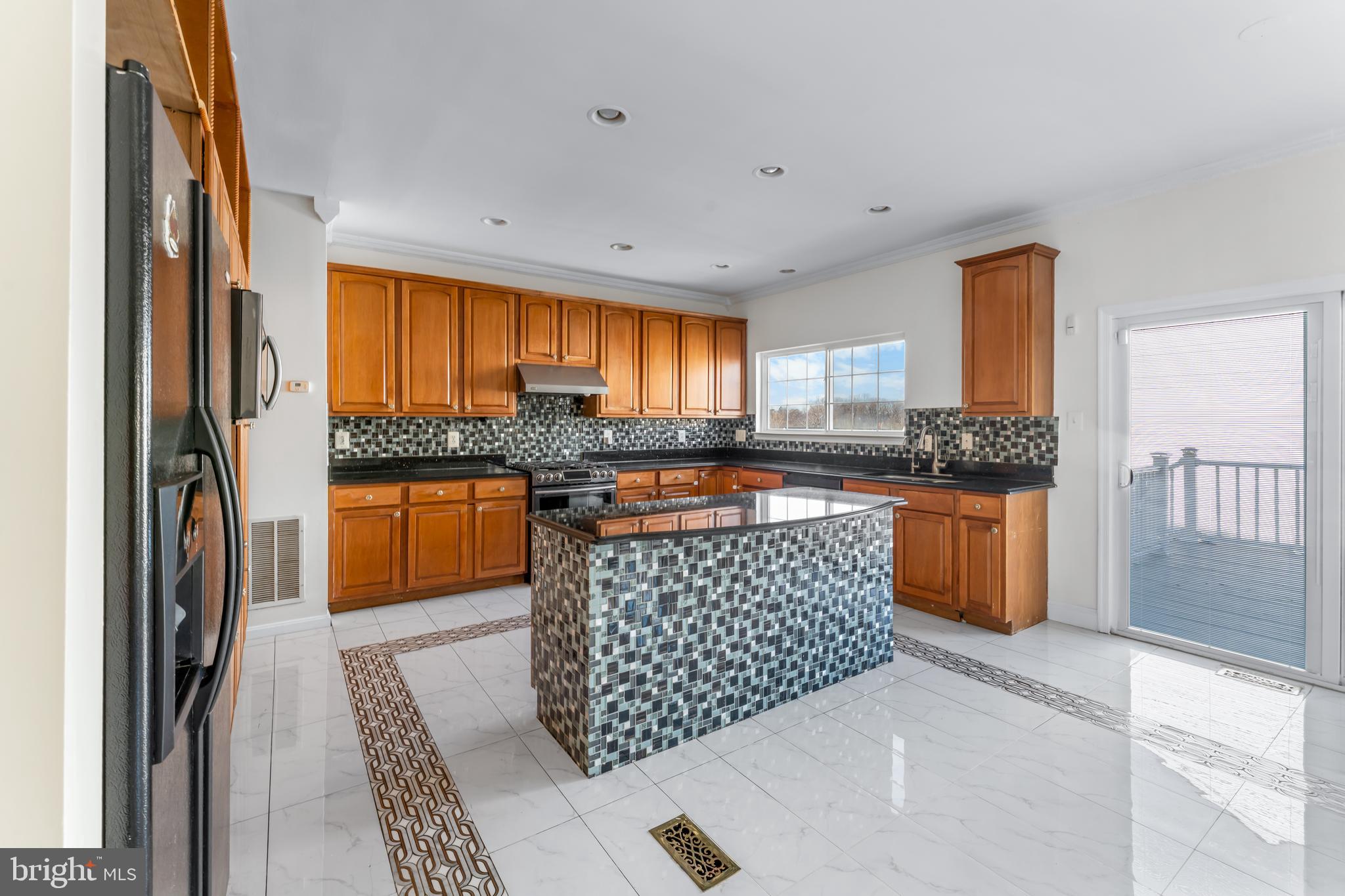 7510 Gilley Terrace Rosedale, MD 21237 - Photo 13 of 46 a kitchen with stainless steel appliances granite countertop a stove a sink and a refrigerator