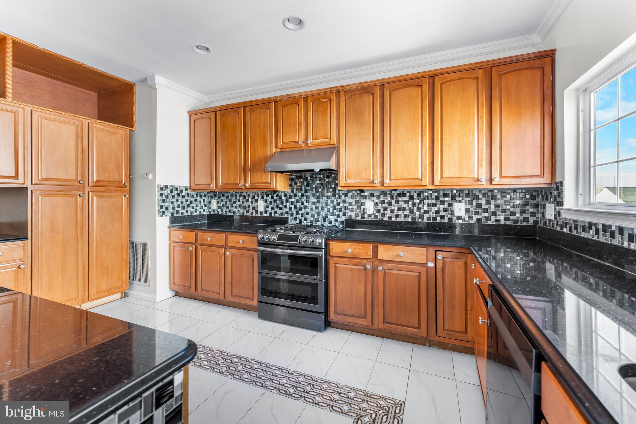 7510 Gilley Terrace Rosedale, MD 21237 - Photo 16 of 46 a kitchen with stainless steel appliances granite countertop a stove a sink and a microwave