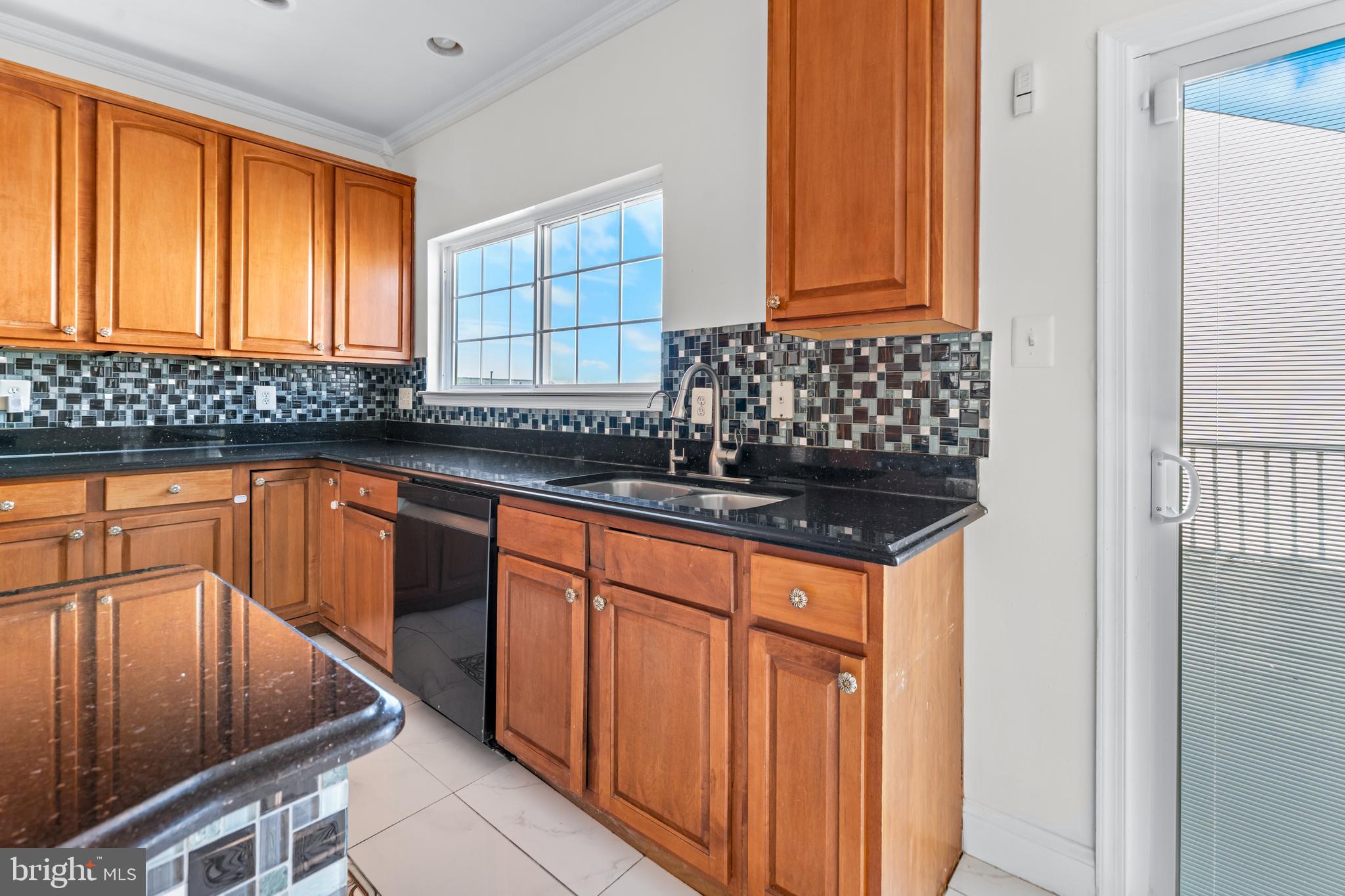 7510 Gilley Terrace Rosedale, MD 21237 - Photo 17 of 46 a kitchen with granite countertop cabinets and window
