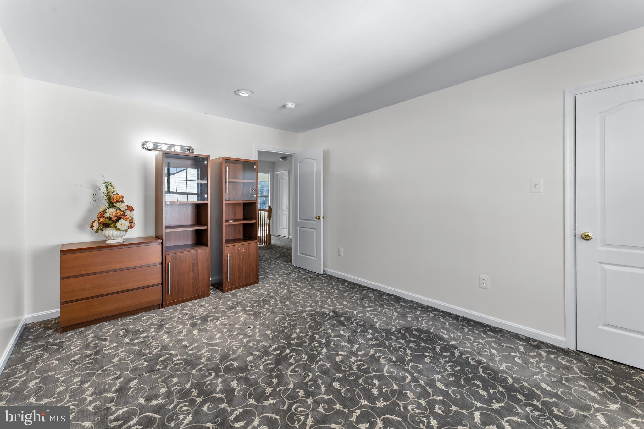 7510 Gilley Terrace Rosedale, MD 21237 - Photo 30 of 46 a room with a bed and cabinets