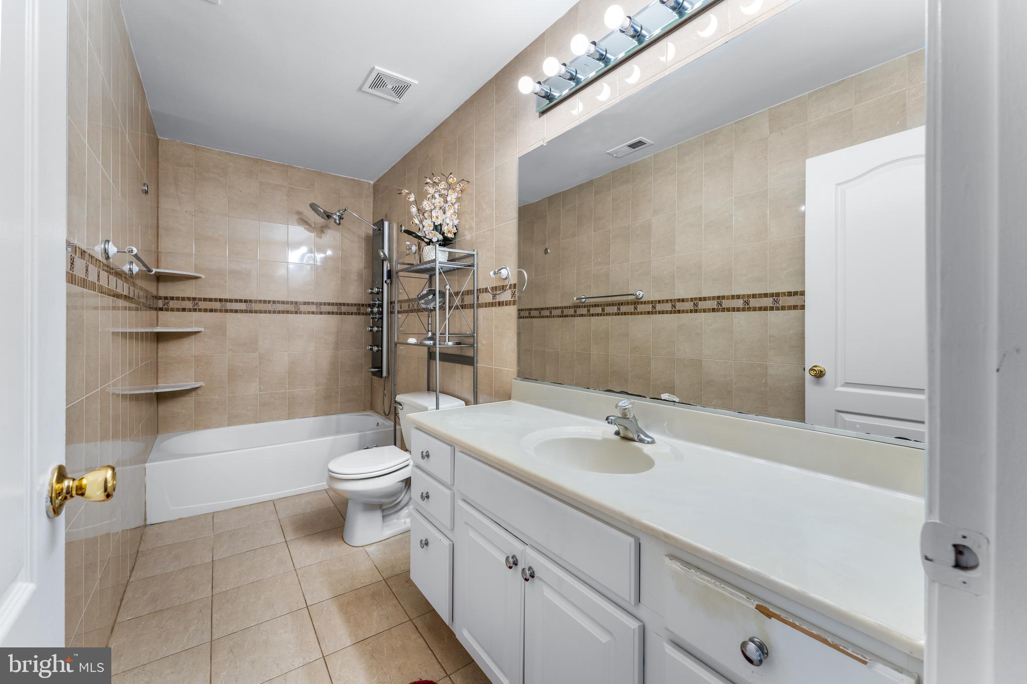 7510 Gilley Terrace Rosedale, MD 21237 - Photo 34 of 46 a bathroom with a sink a toilet and shower