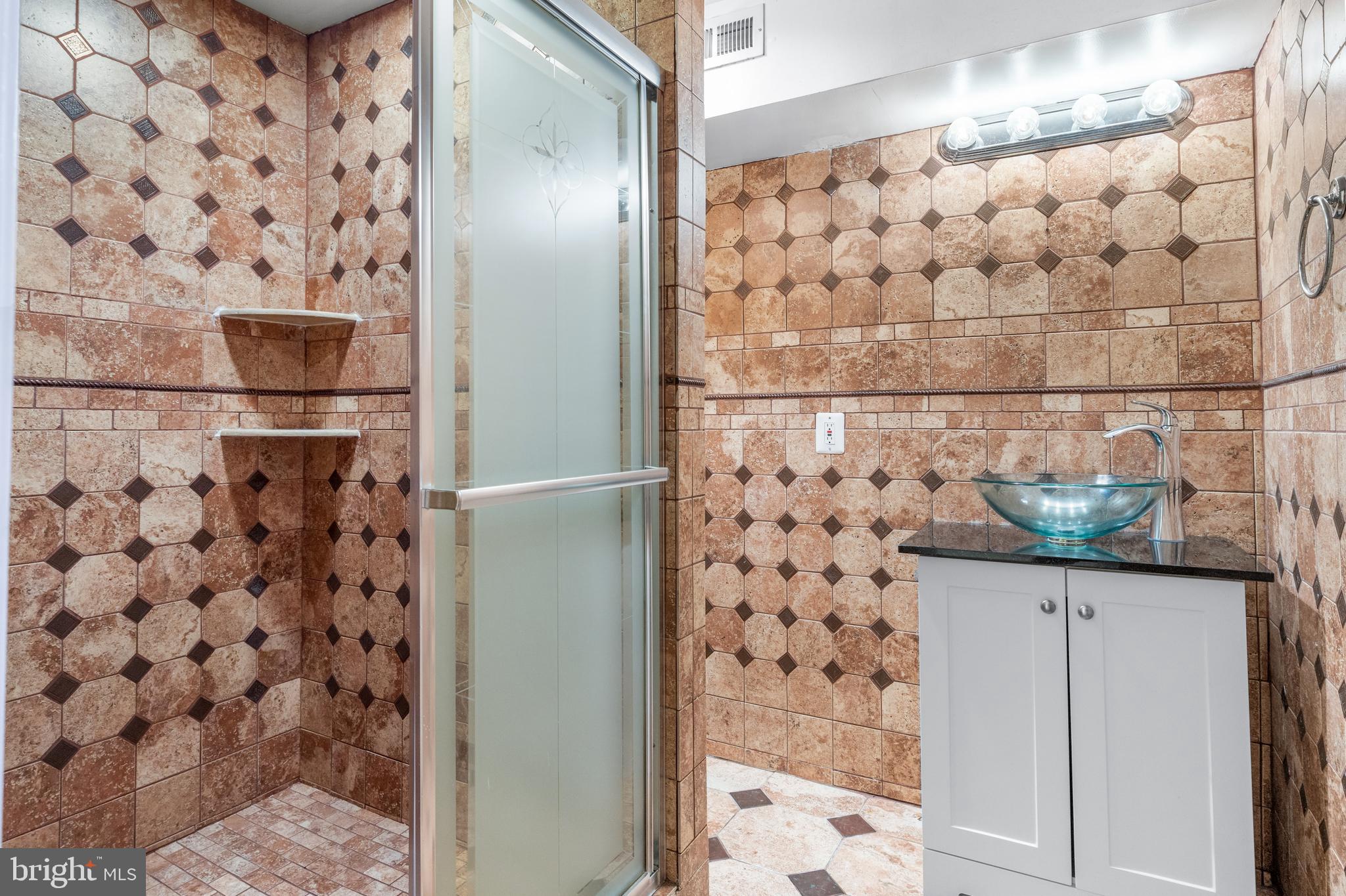 7510 Gilley Terrace Rosedale, MD 21237 - Photo 41 of 46 a bathroom with a bathtub and shower