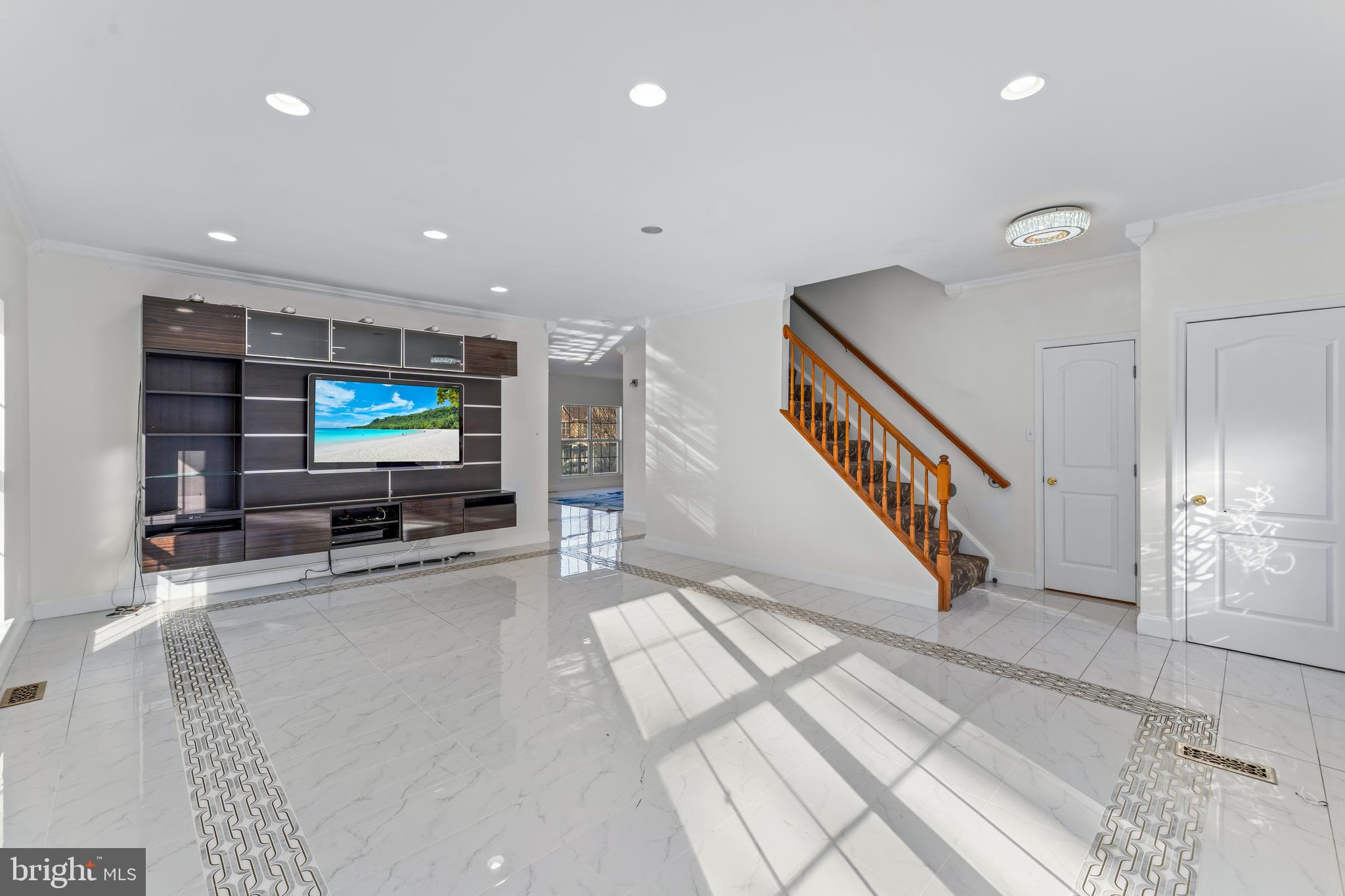 7510 Gilley Terrace Rosedale, MD 21237 - Photo 10 of 46 a room with stairs and a flat screen tv