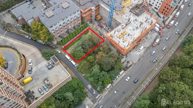 an aerial view of a house with a yard and lake view
