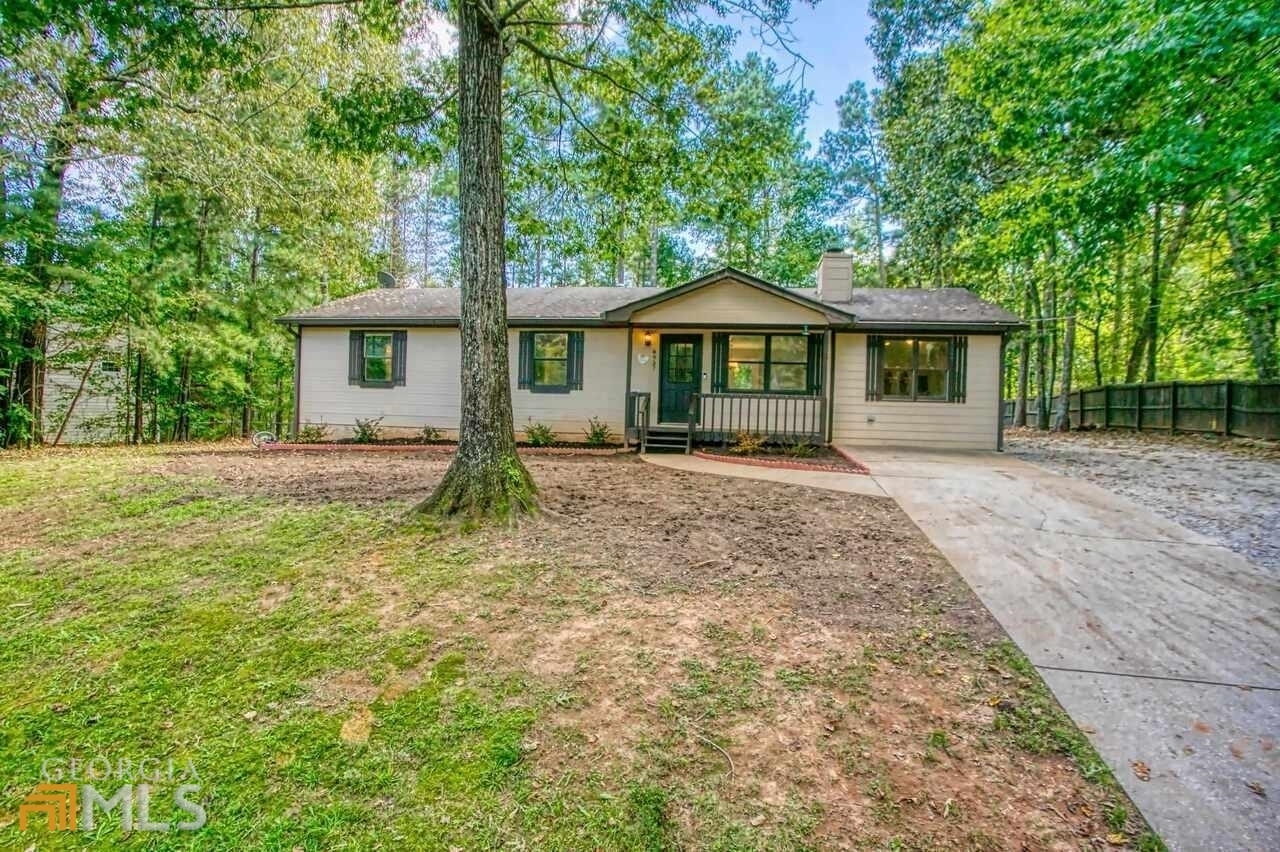 8937 Tweeddale Drive Winston, GA 30187 - Photo 1 of 1 a front view of a house with garden