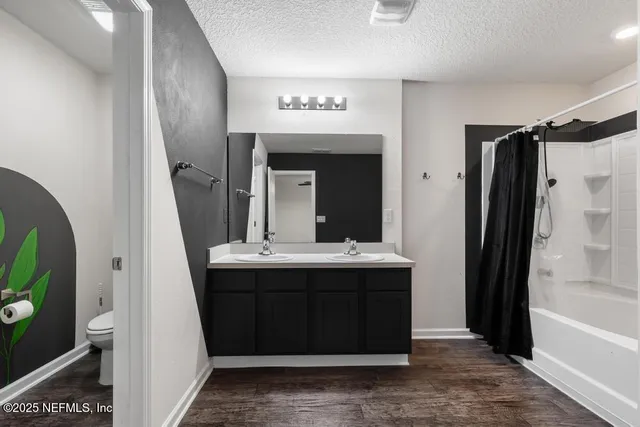 a bathroom with a double vanity sink mirror double and shower