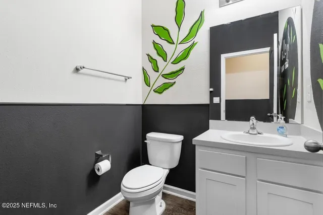 a bathroom with a toilet sink and mirror