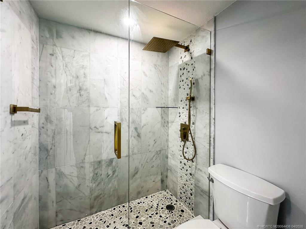 800 Northwest Fork Road, Unit 107 Stuart, FL 34994 - Photo 7 of 21 a bathroom with a shower and a toilet